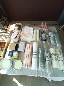 Group of Restaurant To-Go Supplies Including Styrofoam Bowls, Wrapped Plastic Silverware Packs, Plastic carry Out Bags and More