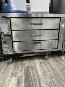 PIZZA OVEN - BAKERS PRIDE DOUBLE STACK PIZZA OVEN. HEAVY DUTY STAINLESS STEEL EXTERIOR. 2 BAKING CHAMBERS WITH 2 IN THICK BAKING DECKS. SPRING BALANCED DOORS. FULLY INSULATED THROUGHT KEEPING IN HEAT. RETAIL $40,000.00