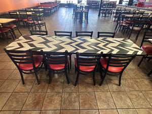 Long Commercial Dining Table with Chevron Pattern Top and (8) Dining Chairs with Red Upholstered Cushioned Seats