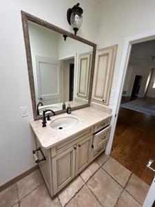 Cream Colored Vanity with Stone Countertop, Large Mirror, Flush Mount Light Fixture, Sink, Tuscan Bronze Faucet and In-Set Medicine Cabinet