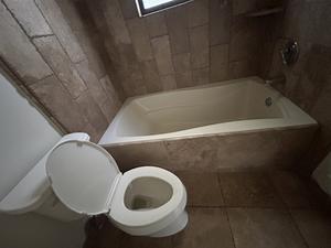 Right-Drain Tub with Brushed Nickel Handles and Elongated Toilet 